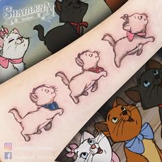 an arm with cartoon cats on it and the caption's written in english