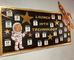 a bulletin board that says launch into technology with an astronaut and stars on the side