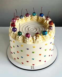 a birthday cake with white frosting and colorful decorations