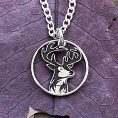 This is a buck deer in a thin rim necklace that we have cut by hand for hunters. It is very sturdy. Try it with our thick metal stainless steel chain. The details of the deer are deeply engraved to last forever!We now have new real silver quarters that are new and in mint condition! These are specialty coins that the mint has made for collectors that have never been in circulation. Our art is really enhanced by using these beautiful silver coins. You also can choose a specific state that has sen Hunting Apparel, Deer Necklace, Silver Quarters, Buck Deer, Hunting Clothes, Animal Jewelry, Silver Coins, Fish Hook, Steel Chain