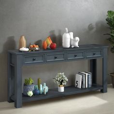 a grey console table with two drawers and vases on top