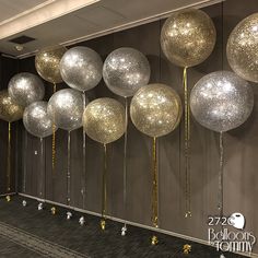 balloons and streamers are lined up against the wall in an office lobby for a party