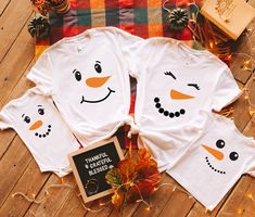 These matching family t-shirts are super soft and comfortable! When placing your order, select both the size and color you would like for the shirt as well as which snowman face you would like.  The last photos in the listing are color charts and sizing charts for reference and the third photo shows the face choices. Shirts are unisex sizing and have more of a men's fit. For a more fitted style, order a size smaller than you usually would. T-Shirts are a cotton/poly blend. STYLE: -Very soft feel -Crew Neck  -Short Sleeves -Side-seamed For orders shipping to the US, there will be two options for shipping speed. Standard shipping time is 3-5 business days and priority shipping time is 2-3 business days. Please contact me with any questions! Care Instructions: -Turn shirt inside out when wash Snowman T Shirt Ideas, White Family Matching T-shirt For Holidays, Snowman Shirts, Kids Christmas Shirts, Christmas Shirts Family, Snowman Costume, Matching Family T Shirts, Snowman Shirt, Family T Shirts