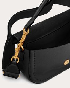 Valentino Garavani Alltime shoulder bag in soft grainy calfskin leather with metallic VLogo Signature detail. The bag can be worn on the shoulder/cross-body or handheld thanks to the removable handle and removable ribbon shoulder strap. Antique brass-finish hardware - Magnetic closure - Removable leather handle - Adjustable and removable fabric shoulder strap - Shoulder strap drop length: 53 cm / 20.8 in. Dimensions: W23.5xH18xD8 cm / W9.3xH7xD2.8 in. - Made in Italy Armani Wallet, Armani Belt, Ferragamo Belt, Fendi Belt, Saint Laurent Wallet, Prada Wallet, Fendi Wallet, Dior Wallet, Chanel Belt