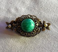 Vintage Original by Robert brooch with a green Peking glass cabochon and two seed pearls seated in the center of the two outer flowers.  In beautiful vintage condition, signed Original by Robert on the back.  Measures approx. 1¾" length x 1" wide. Check out my wide variety of other vintage and MCM Listings Here: https://vintagevalleyvariety.etsy.com Pearl Brooch, Seed Pearl, Lapel Pin, Vintage Signs, Lapel Pins, Brooch Pin, Brooches, Vintage Jewelry, Seeds