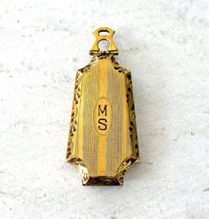 Antique Edwardian Gold Filled Locket Bullet Shape Engraved Cover Initials MS

A gorgeous unusual Edwardian bullet locket in yellow gold filled metal. Beautifully made, the edges are hand carved and the covers are engraved with a pinstripe pattern. The front cover is engraved with the initials MS.

It has a custom hinged bail in a lovely shape, instead of the usual two rings. The shape resembles the letter A in an Art Nouveau font.

There are two photos inside the locket. The covers are ori Art Nouveau Font, The Letter A, Pinstripe Pattern, Maker’s Mark, New Romantics, Letter A, Gold Hair, Gold Filled Chain, 10k Gold