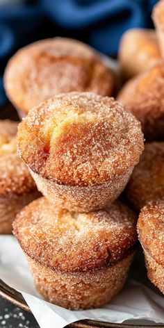 some sugared doughnuts are stacked on top of each other in a plate