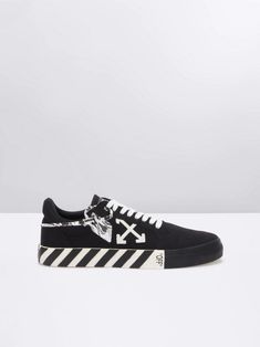 Shop Black/white cotton Vulcanized low-top sneakers from OFF-WHITE featuring logo patch to the side, logo patch at the tongue, round toe, front lace-up fastening, striped flat sole and marbled security tag to the side. Due to the dyeing process used, this product must not come into contact with water.. Streetwear Skate Shoes With Logo-print Tongue, Urban High-top Sneakers With Logo-print Tongue, Low-top Skate Shoes With Logo-print Tongue For Streetwear, Casual Lace-up Skate Shoes With Logo-print Tongue, Canvas High-top Sneakers With Logo Print For Streetwear, Streetwear Lace-up Skate Shoes With Logo, Lace-up Skate Shoes With Logo For Streetwear, Black Canvas Sneakers With Logo Print, Low-top Sneakers With Logo Print For Skateboarding