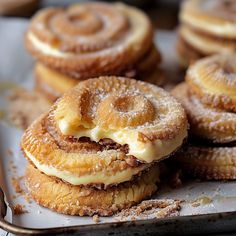 several pastries sitting on top of a pan covered in powdered sugar and icing