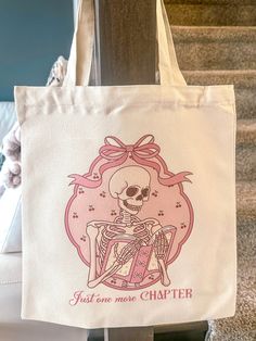 a white tote bag with a skeleton sitting on it's back and the words just give me one charter