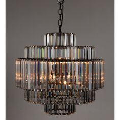 a chandelier hanging from the ceiling with many lights on top of it,