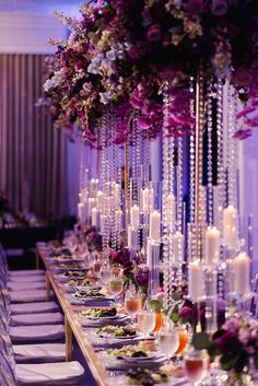 a long table with candles and flowers on it