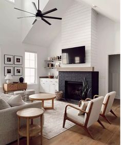 a living room filled with furniture and a flat screen tv mounted on the wall above a fireplace