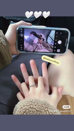 a person taking a photo with their cell phone in the back seat of a car