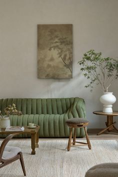 a living room filled with furniture and a painting on the wall