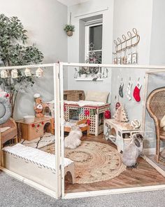 a doll house with furniture and accessories in the living room, including two cats sitting on the floor