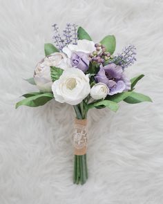 a bridal bouquet with purple and white flowers