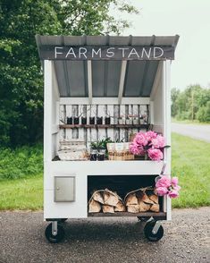 a small food cart with flowers and jars on it