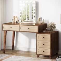 a wooden desk with two drawers and a mirror on the wall above it, in front of a window