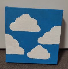 a blue and white painting with clouds painted on it