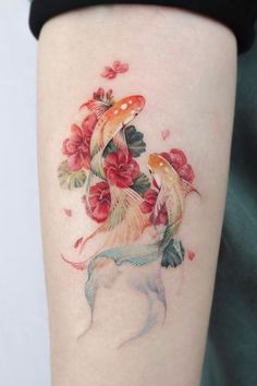 a woman's arm with a dog and flowers on it