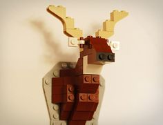 a close up of a toy made out of legos with a deer on it's head