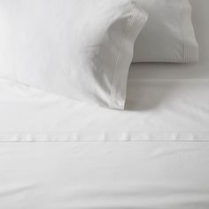 white sheets and pillows on top of each other