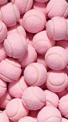 a pile of pink tennis balls sitting on top of each other