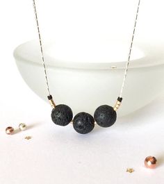 This beautiful minimalist necklace is made with amazing lava stone. Wear as is, or add a couple drops of your favourite essential oils to this natural lava rock diffuser, and experience wonderful aromatherapy! This simple everyday necklace is also a great for layering or lovely worn on its own.  🌿 This necklace has three 8mm size lava beads accented with premium gold and matte black seed beads. 🌿 Strung on a beautiful dainty sterling silver beading chain. Choose your length at checkout. 🌿 Your lovely necklace will come beautifully wrapped in tissue, a pretty organza/ cloth bag and ribbon ready for gift giving! PLEASE - READ - MY - POLICIES & FAQ https://www.etsy.com/shop/aprilhyltondesigns/policy Q U E S T I O N S  If you have any questions, please feel free to contact me here on Etsy. Lava Stone Necklace With Natural Stones For Gift, Black Lava Stone Necklace For Gift, Minimalist Adjustable Lava Stone Jewelry, Everyday Lava Stone Jewelry With Natural Stones, Essential Oil Necklace, Lava Stone Necklace, Simple Necklace Everyday, Essential Oil Necklaces, Essential Oil Necklace Diffuser