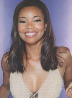 a woman smiling and wearing a white top