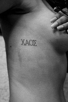 a woman's chest with the word xoaz tattooed on her left side