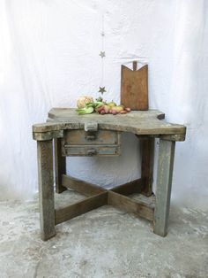 an old wooden table with some fruit on it