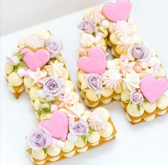 the letter k is made out of cookies with flowers and hearts on it's sides