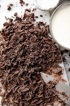 chocolate shavings next to a glass of milk