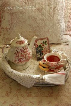 a tea pot and some cookies on a tray