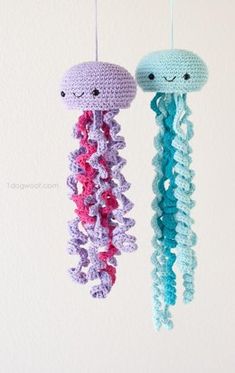 two crocheted jellyfish mobiles hanging from strings