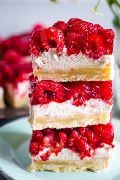 three pieces of cake sitting on top of a white plate with flowers in the background