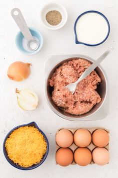 eggs, cheese and meat in bowls on a table