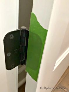 an open door with a green piece of paper taped to the front and back of it