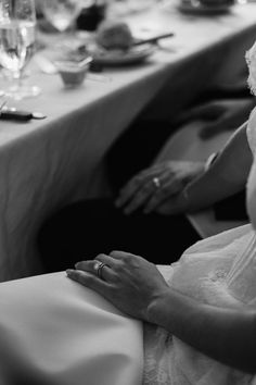 a woman in a wedding dress sitting at a table