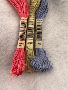 three skeins of yarn sitting next to each other