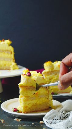 a person cutting into a piece of cake on a plate with a knife and fork