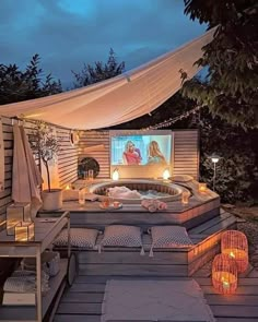 a hot tub sitting on top of a wooden deck next to a gazebo covered in lights