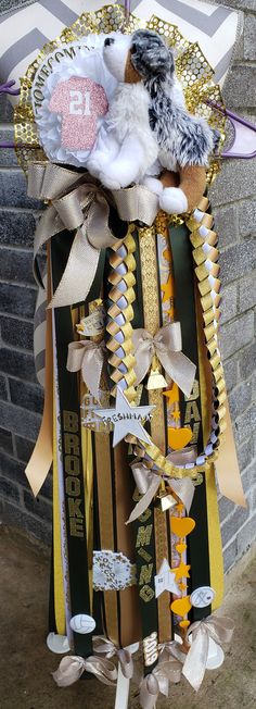 a bunch of ribbons hanging from the side of a building with a stuffed animal in it