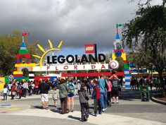 the entrance to legoland florida with lots of people standing in front and looking at it