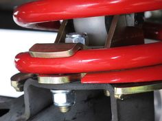 the red hoses are connected to the machine's control knobs and levers