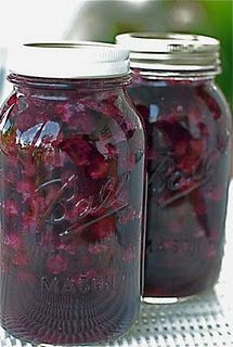 three jars filled with red liquid sitting on top of a table