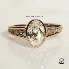 a close up of a ring on a white surface with the words ruamasy jewelry