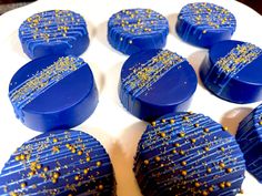 chocolates with gold sprinkles are arranged on a white plate, ready to be eaten