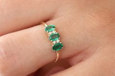 "Oval Emerald Ring / 14k Solid Gold Natural Genuine Emerald and Diamond Ring / Green Gemstone Ring / Green Emerald / Emerald Jewelry Item Details *Made to Order. *Gold Kt: 14K Solid Gold *Custom Gold Color: Rose Gold, Yellow Gold, White Gold *Round Diamond: 4 Pcs 1.20MM *Oval Emerald: 3 Pcs 5x3MM *Total Diamond tTW: 0.05ctw *Total Emerald ctw: 0.65ctw *Diamond Color-Clarity: G Color SI Clarity *Width of Band: 1.3MM *Setting Type: Prong *Ready to Ship in 7-10 Business Days If you have any additio Elegant Three Stone Birthstone Ring In 14k Gold, Elegant Three-stone Birthstone Ring In 14k Gold, Gold Oval Emerald Ring, Elegant Three Stone 14k Gold Jewelry, Elegant Multi-stone Emerald Ring In 14k Gold, Elegant 14k Gold Multi-stone Emerald Ring, Elegant Multi-stone Emerald Birthstone Ring, Black Diamond Earrings Studs, Moissanite Engagement Ring Rose Gold